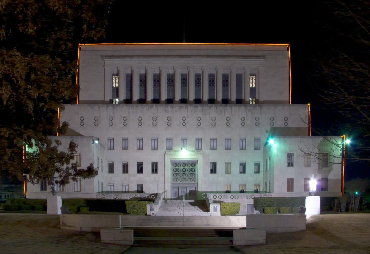 Large model of a building at night with illuminated windows