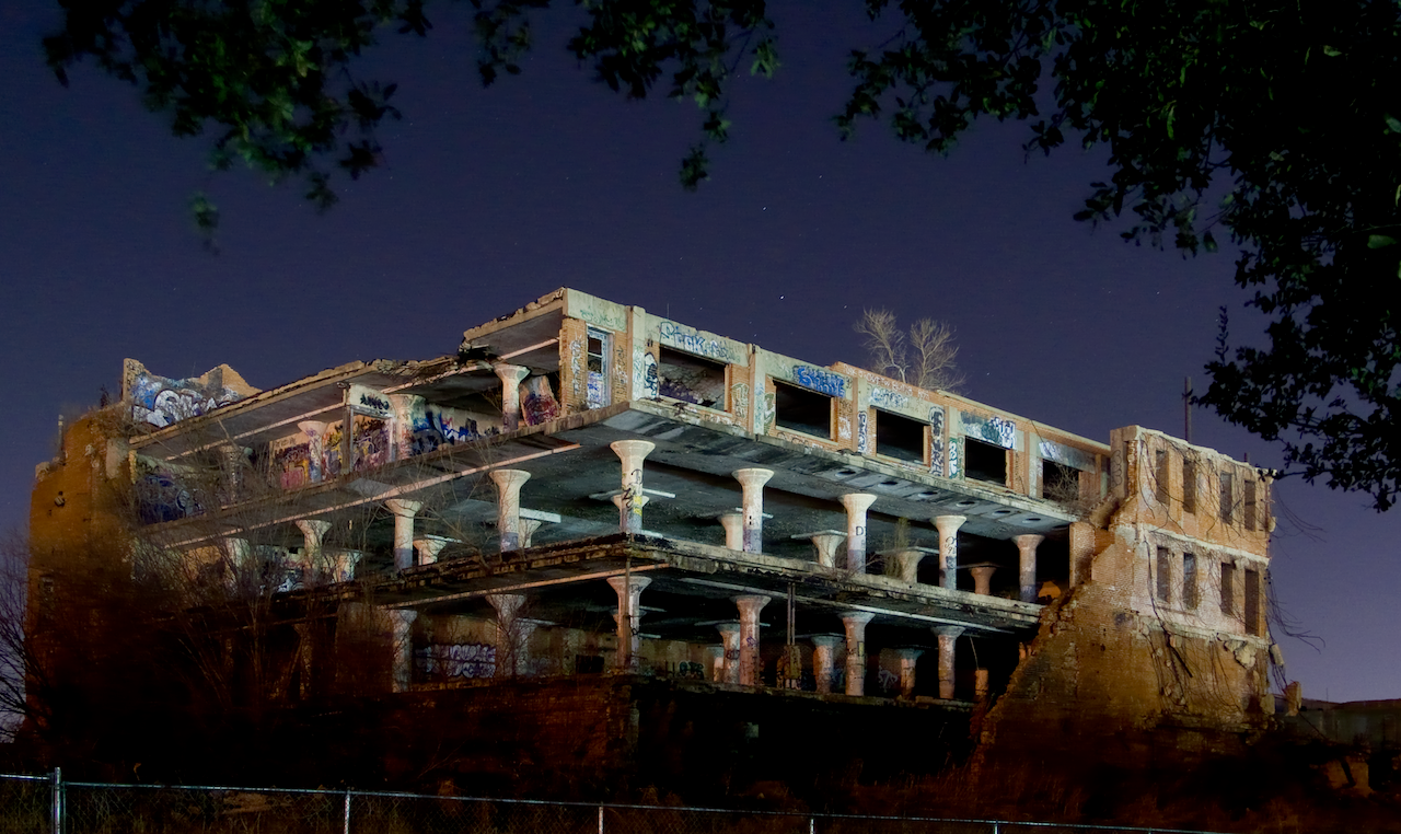 Abandoned building at night with a dark sky. Remains of the Swift Meatpacking Headquarters.